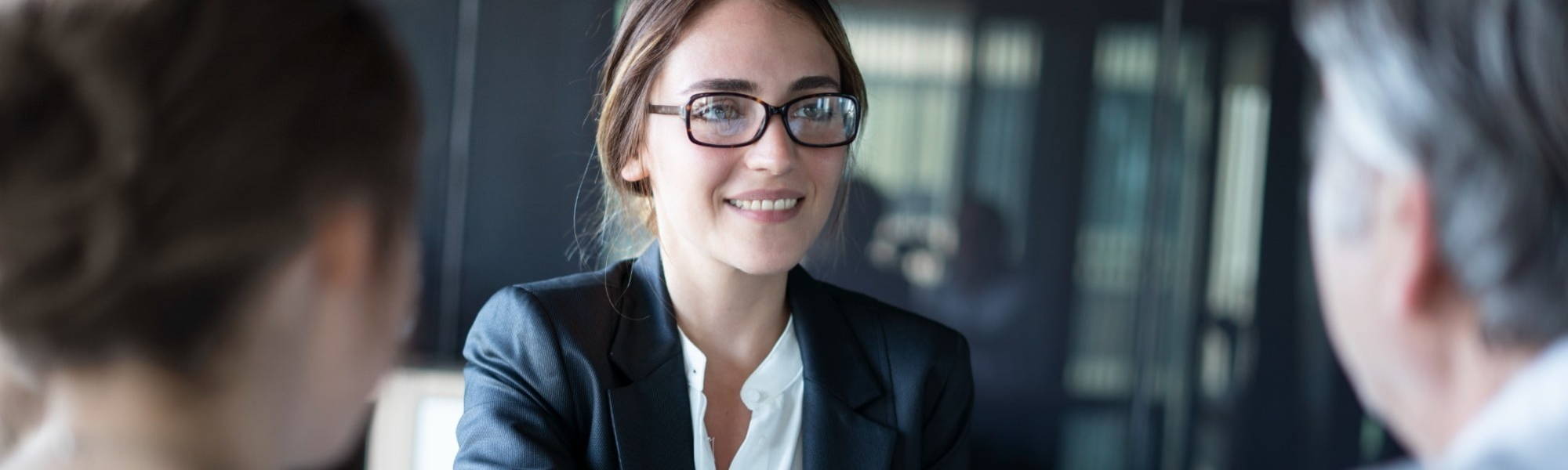 Young female in business suit having interview meeting with prospective employer